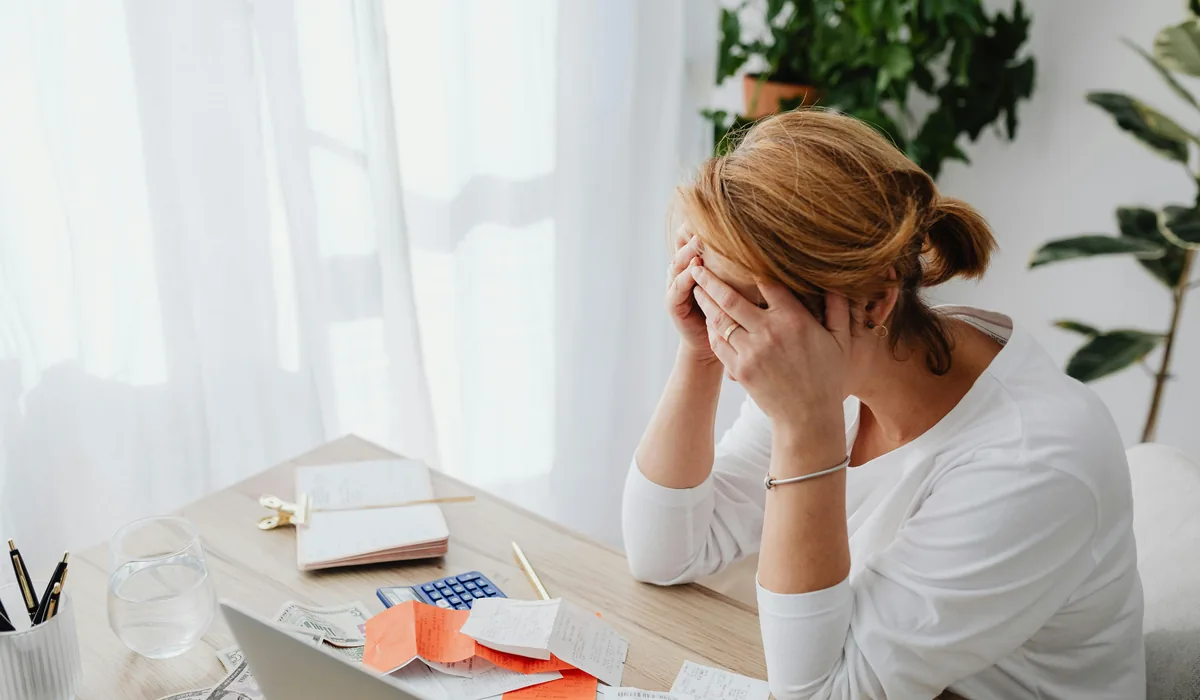 Woman stressed over bills and receipts needing a small loan with bad credit